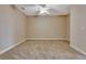 A simple, sunlit bedroom with wall-to-wall carpeting and a ceiling fan at 1942 Michael Tiago Cir, Maitland, FL 32751