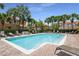 Spacious community pool area surrounded by palm trees and comfortable lounge chairs at 1942 Michael Tiago Cir, Maitland, FL 32751