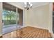 Hardwood floors and a sliding glass door that leads to a covered patio in this dining space at 1942 Michael Tiago Cir, Maitland, FL 32751