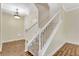 Inviting entryway with wood floors, chandelier, and staircase with white wood banister and carpeted steps at 1942 Michael Tiago Cir, Maitland, FL 32751