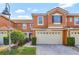 Charming townhouse featuring a two-car garage, tile roof, and well-maintained landscaping at 1942 Michael Tiago Cir, Maitland, FL 32751