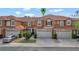 Charming townhome with a tile roof, two-car garage, and neatly landscaped front yard at 1942 Michael Tiago Cir, Maitland, FL 32751