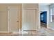 Hallway with tile floors, closet with bi-fold doors, a standard door, and bright window at 1942 Michael Tiago Cir, Maitland, FL 32751
