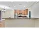 Eat-in kitchen featuring granite countertops, stainless steel appliances, and ample cabinet space at 1942 Michael Tiago Cir, Maitland, FL 32751