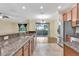 Open kitchen showcasing granite countertops, stainless steel appliances, and adjacent dining area at 1942 Michael Tiago Cir, Maitland, FL 32751