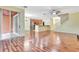 Open living space boasts hardwood floors, a view of the kitchen, staircase, and covered patio at 1942 Michael Tiago Cir, Maitland, FL 32751