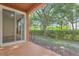 Private patio with a sliding glass door and a view of the lush greenery at 1942 Michael Tiago Cir, Maitland, FL 32751