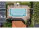 Aerial view of the community pool featuring lounge chairs, landscaped surroundings, and parking area at 1942 Michael Tiago Cir, Maitland, FL 32751