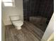 Modern bathroom with white brick accent wall and black tiled shower with seat at 1985 Japonica Rd, Winter Park, FL 32792