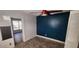 Bedroom with a red ceiling fan, blue accent wall, and wood-look flooring at 1985 Japonica Rd, Winter Park, FL 32792
