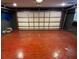 Garage with a red painted concrete floor and a metal garage door at 1985 Japonica Rd, Winter Park, FL 32792