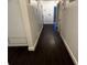 Hallway featuring dark wood-look flooring and neutral wall paint at 1985 Japonica Rd, Winter Park, FL 32792