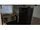 Functional kitchen with white cabinetry and a black refrigerator at 1985 Japonica Rd, Winter Park, FL 32792