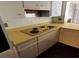 Kitchen with yellow countertops, white cabinetry, and a white subway tile backsplash at 1985 Japonica Rd, Winter Park, FL 32792