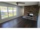 Inviting living room with brick fireplace and dark laminate flooring at 1985 Japonica Rd, Winter Park, FL 32792
