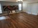 Spacious living room boasting laminate wood floors, ample natural light, and modern wall art at 1985 Japonica Rd, Winter Park, FL 32792