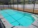 Backyard pool area with a screened-in enclosure and surrounding patio space at 1985 Japonica Rd, Winter Park, FL 32792