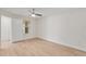 Bright bedroom with wood-look flooring, ceiling fan, and natural light from the window at 2213 Grand Cayman Ct # 1138, Kissimmee, FL 34741