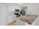 Modern kitchen featuring granite countertops and stainless steel appliances, creating a stylish and functional cooking space at 2213 Grand Cayman Ct # 1138, Kissimmee, FL 34741
