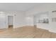 Spacious living room with laminate floors, seamlessly connecting to a modern kitchen with white cabinetry and granite countertops at 2213 Grand Cayman Ct # 1138, Kissimmee, FL 34741