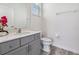 Neutral bathroom featuring a gray vanity, modern fixtures, and clean, minimalist design elements at 2574 Shanti Dr, Kissimmee, FL 34746