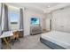 Bright bedroom offers a sleek desk, comfortable bed, modern dresser, and a large window with picturesque views at 2574 Shanti Dr, Kissimmee, FL 34746