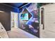 Themed bedroom featuring a vibrant wall mural with a television and private bathroom access at 2574 Shanti Dr, Kissimmee, FL 34746
