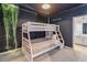 Themed bedroom with a cozy bunk bed and an adjacent bathroom offering a unique living experience at 2574 Shanti Dr, Kissimmee, FL 34746