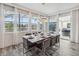 Bright dining room with a modern table, seating for six, and sliding glass doors leading to the patio at 2574 Shanti Dr, Kissimmee, FL 34746