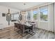 Elegant dining room with modern chandelier, a table set for six, and natural light from surrounding windows at 2574 Shanti Dr, Kissimmee, FL 34746