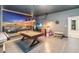 An entertainment space featuring a mural, game table, tv, dart board, and a snack area at 2574 Shanti Dr, Kissimmee, FL 34746