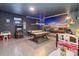 Spacious game room with pool table, foosball, arcade machine, mural, and unique lighting at 2574 Shanti Dr, Kissimmee, FL 34746