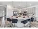 Modern kitchen with pendant lighting, stainless steel appliances, white countertops, and seating at 2574 Shanti Dr, Kissimmee, FL 34746