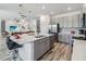 Bright kitchen with island seating, stainless appliances, and modern cabinetry in an open-concept layout at 2574 Shanti Dr, Kissimmee, FL 34746