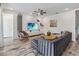 Cozy living room with modern furniture, wood-look flooring, and a TV mounted on the wall at 2574 Shanti Dr, Kissimmee, FL 34746