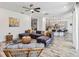 Open-concept living room that flows into a kitchen with modern furniture and flooring at 2574 Shanti Dr, Kissimmee, FL 34746