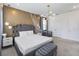 Sleek bedroom showcasing decorative wall accents, a modern light fixture and a comfortable sleeping space at 2574 Shanti Dr, Kissimmee, FL 34746
