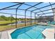 Sparkling pool and hot tub with screened enclosure offer picturesque views and endless relaxation opportunities at 2574 Shanti Dr, Kissimmee, FL 34746