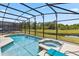 Screened pool and hot tub overlook tranquil water views, providing a perfect blend of relaxation and natural beauty at 2574 Shanti Dr, Kissimmee, FL 34746