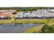 Beautiful backyard of a home with a screened pool, overlooking a serene lake, in a Gathering-friendly community at 2574 Shanti Dr, Kissimmee, FL 34746