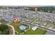 Aerial view of a neighborhood with a pool and park, showcasing the community's layout at 2591 Seagirt Way, Clermont, FL 34711