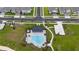 Aerial view of the community pool and clubhouse with palm trees and lounge chairs at 2591 Seagirt Way, Clermont, FL 34711
