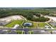 Aerial view of the community pool and clubhouse surrounded by green spaces and walking paths at 2591 Seagirt Way, Clermont, FL 34711