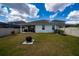 Spacious backyard with a grill, fire pit, and patio, perfect for outdoor entertaining at 2591 Seagirt Way, Clermont, FL 34711