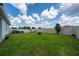 Large, well-maintained backyard with lush green grass and a white privacy fence, perfect for outdoor activities at 2591 Seagirt Way, Clermont, FL 34711