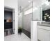 Modern bathroom includes walk-in shower, stylish fixtures, and a peek into a walk-in closet at 2591 Seagirt Way, Clermont, FL 34711