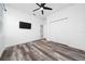 Bedroom features a ceiling fan, closet, doorway, and a mounted TV at 2591 Seagirt Way, Clermont, FL 34711
