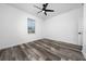 Bright bedroom features a modern ceiling fan, a window and stylish wood-look flooring at 2591 Seagirt Way, Clermont, FL 34711