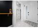 Bright entryway with white tile flooring and a stylish accent wall at 2591 Seagirt Way, Clermont, FL 34711