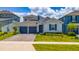 Charming single-Gathering home boasts a well-manicured lawn and a two-car garage for ample parking at 2591 Seagirt Way, Clermont, FL 34711